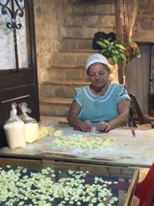 An old woman making orecchiette pasta in the center of Bari, Puglia.